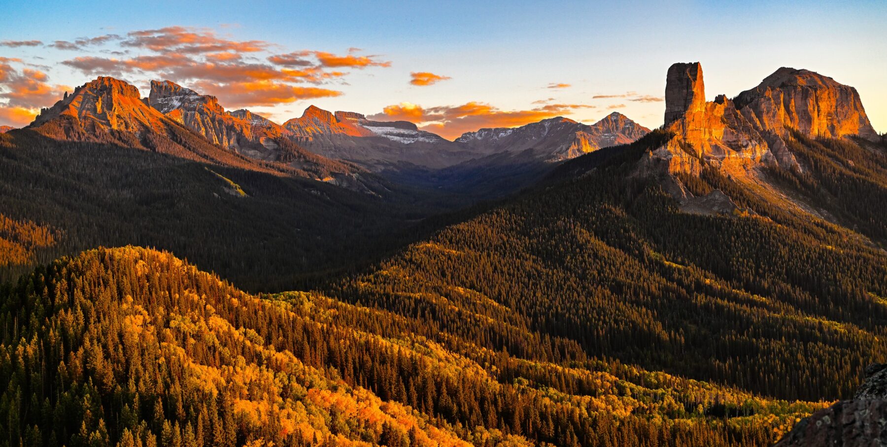 Chimney Rock and the surrounding mountains in golden autumn light