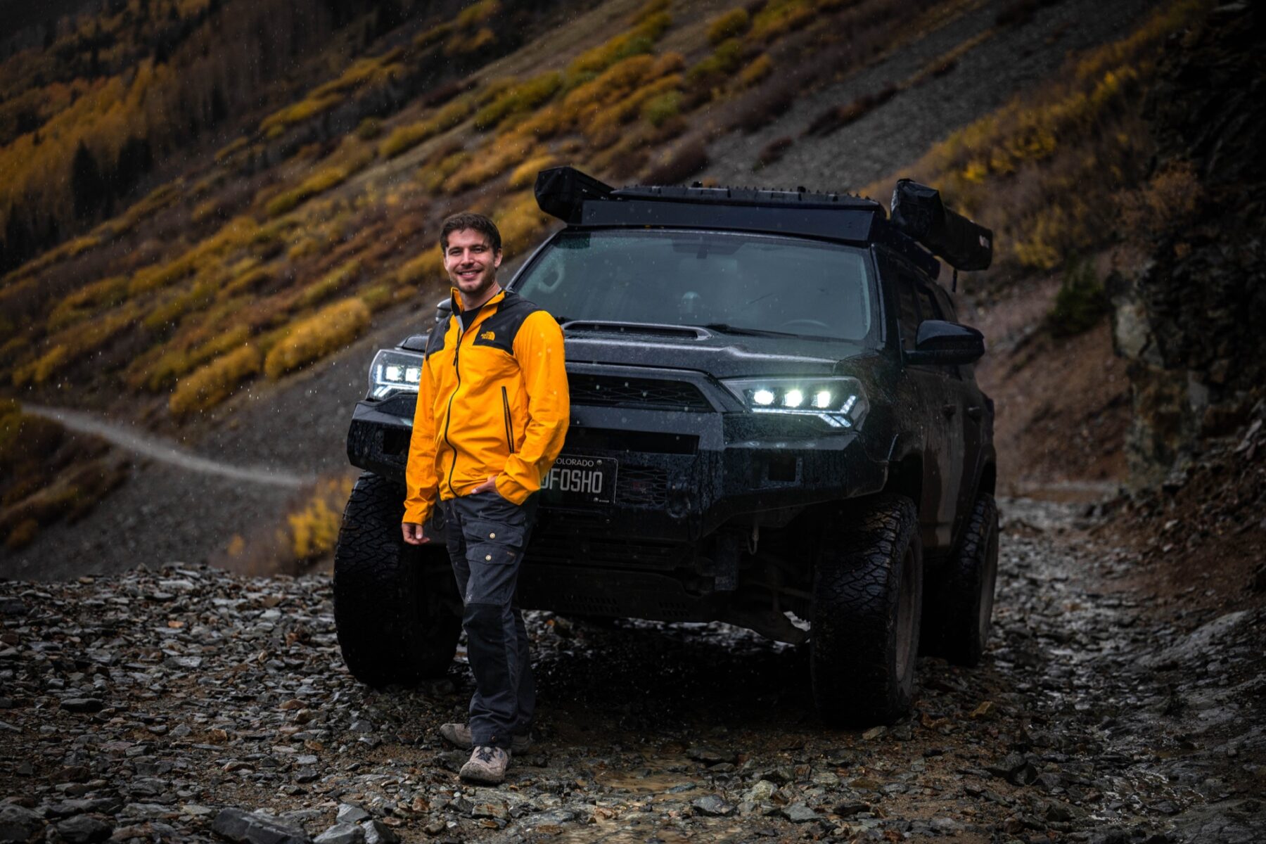 Corbin Kinsch beside his vehicle on Ophir Pass, Colorado